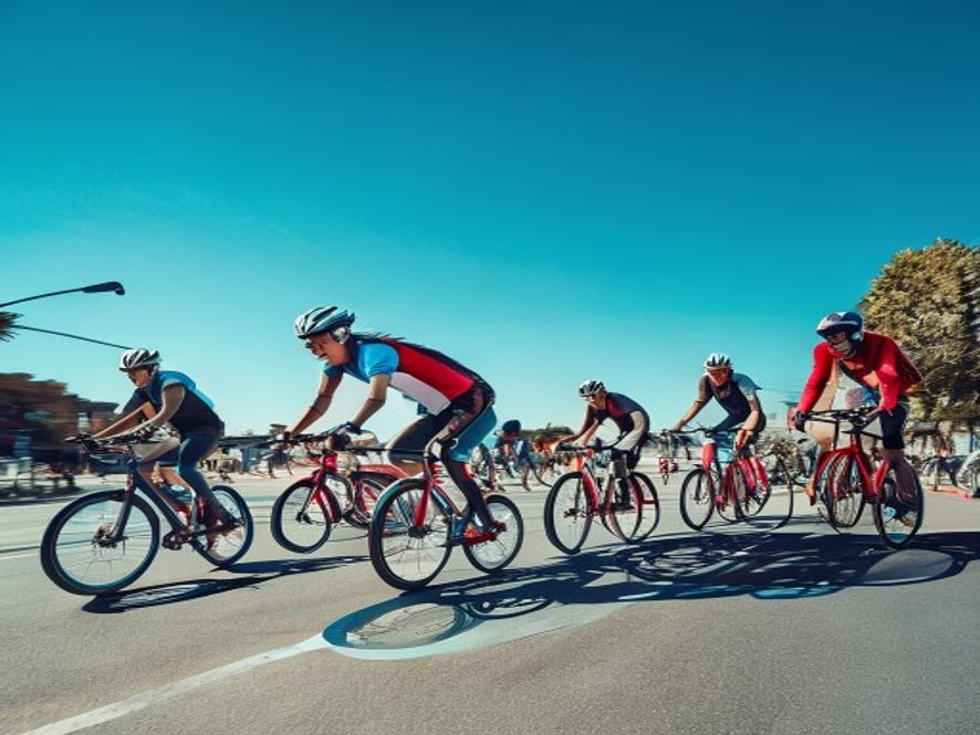 A group of cyclists pausing during a ride at a scenic viewpoint overlooking London