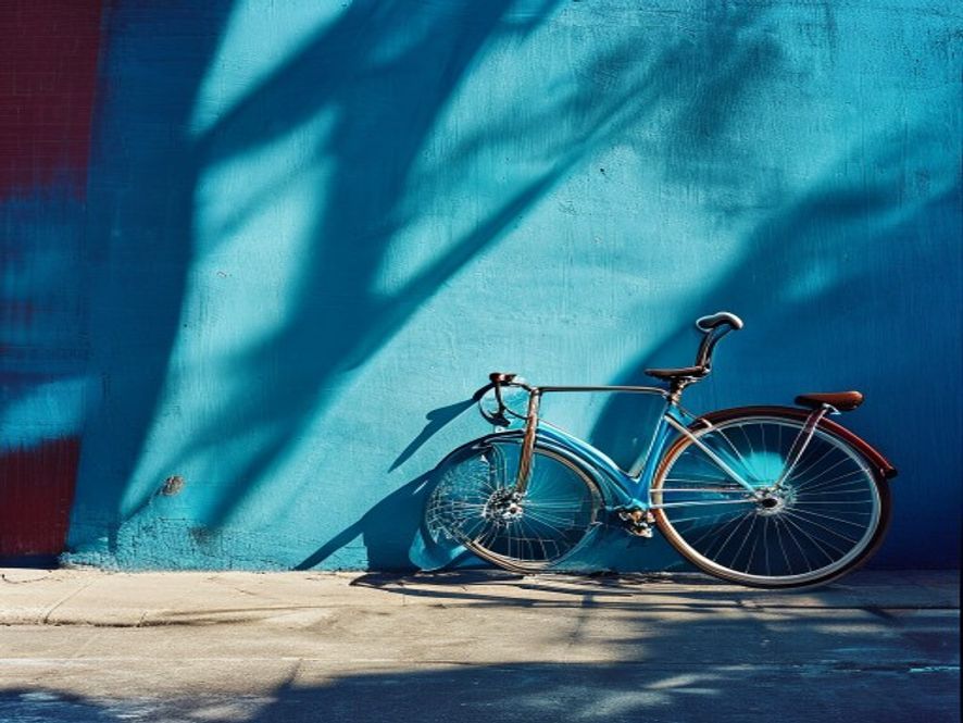 Bicycle leaning against a bright blue wall in central London